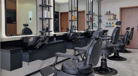 Stylish interior of Pitstop Barbers in Dubai, AE, showcasing sleek black barber chairs and modern decor.