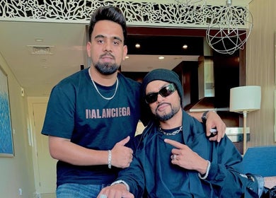 Two stylish men inside Pitstop Barbers, showcasing trendy fashion in Dubai, AE.