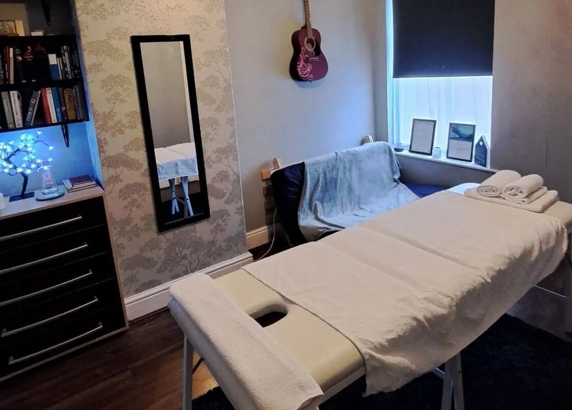 Cozy massage room at EA Massage Therapy, Grimsby, England, GB, featuring soft lighting with elegant decor.