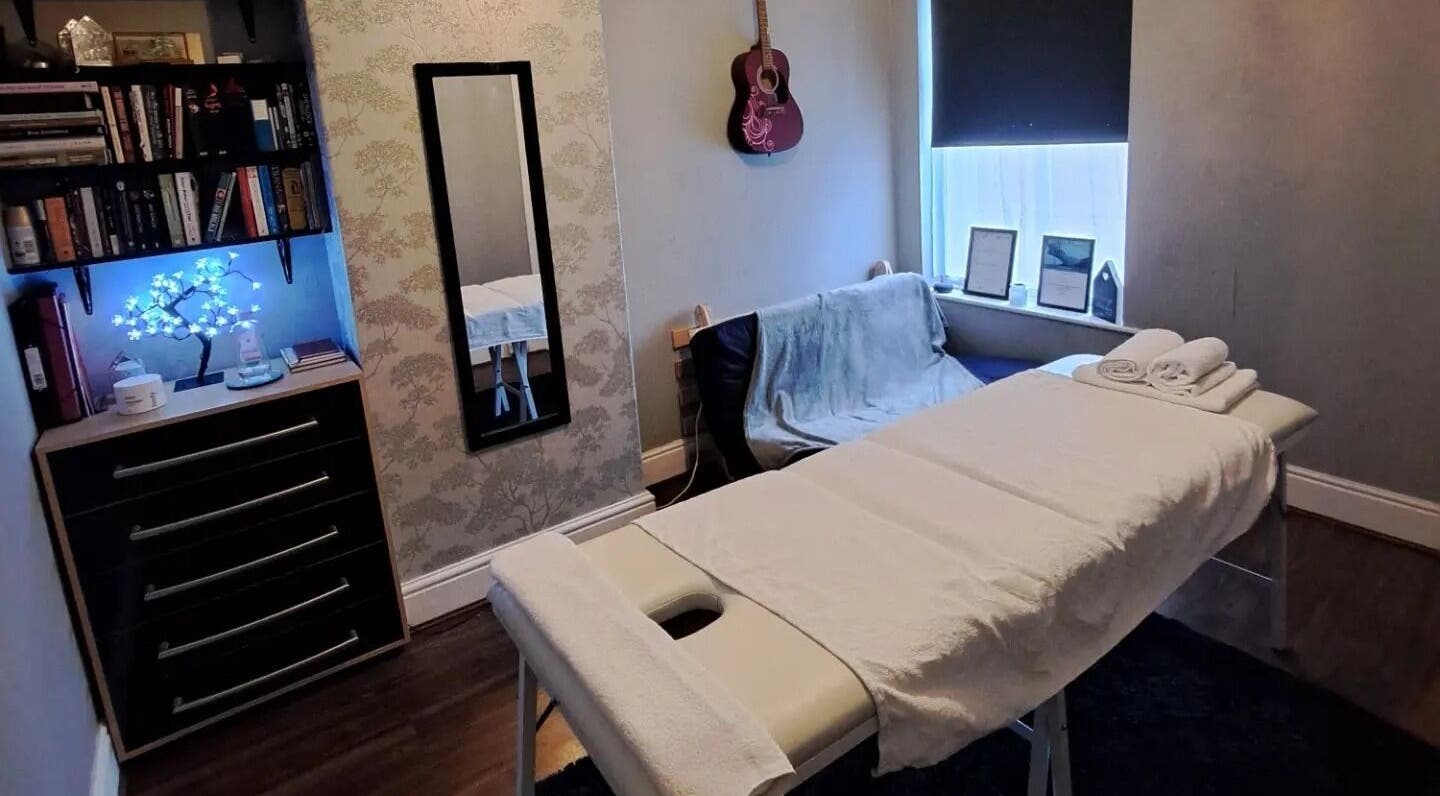Cozy massage room at EA Massage Therapy, Grimsby, England, GB, featuring soft lighting with elegant decor.