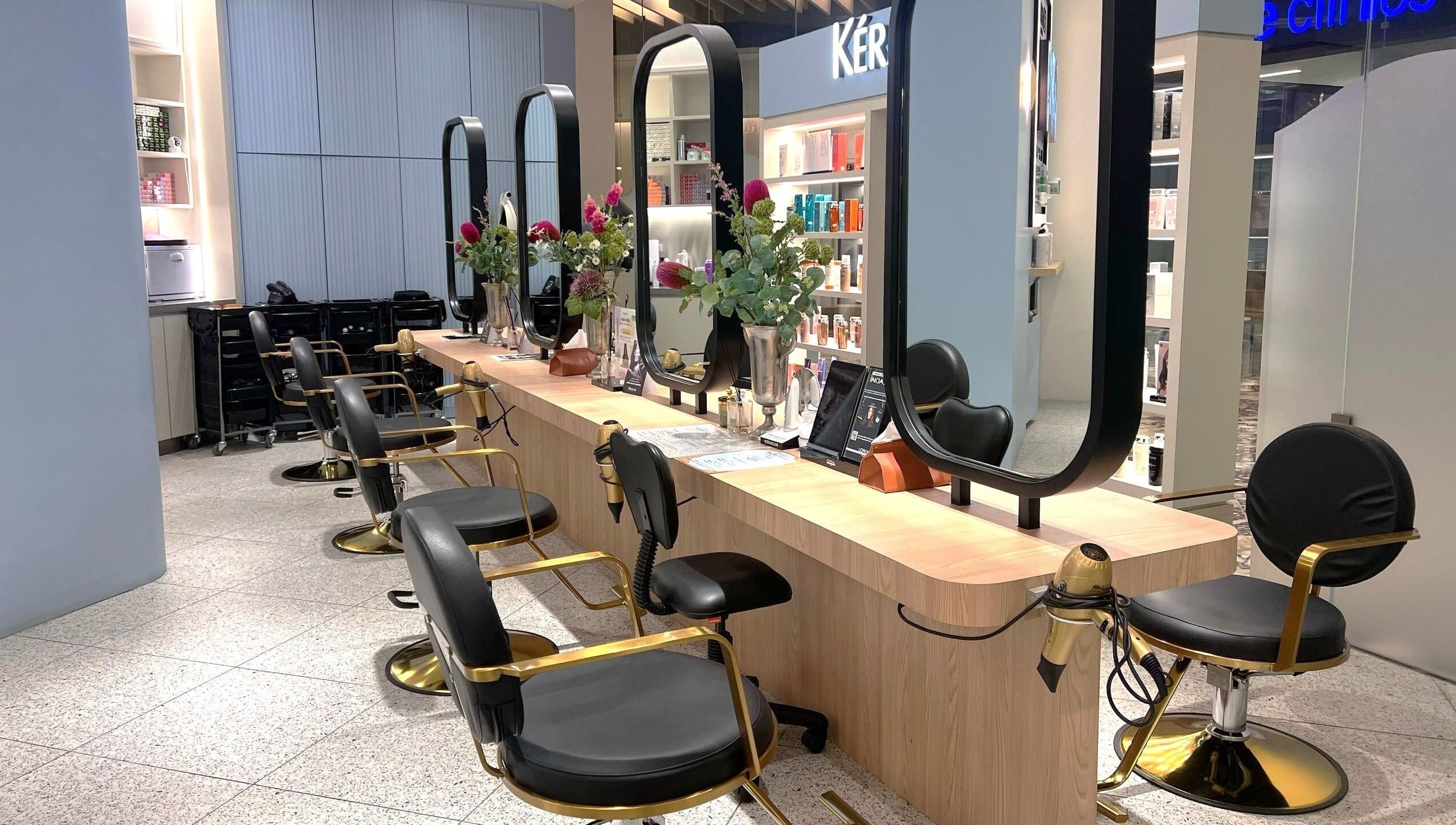Elegant salon at Muse 106, Kuala Lumpur, features modern styling chairs and mirrors. A stylish beauty hub.