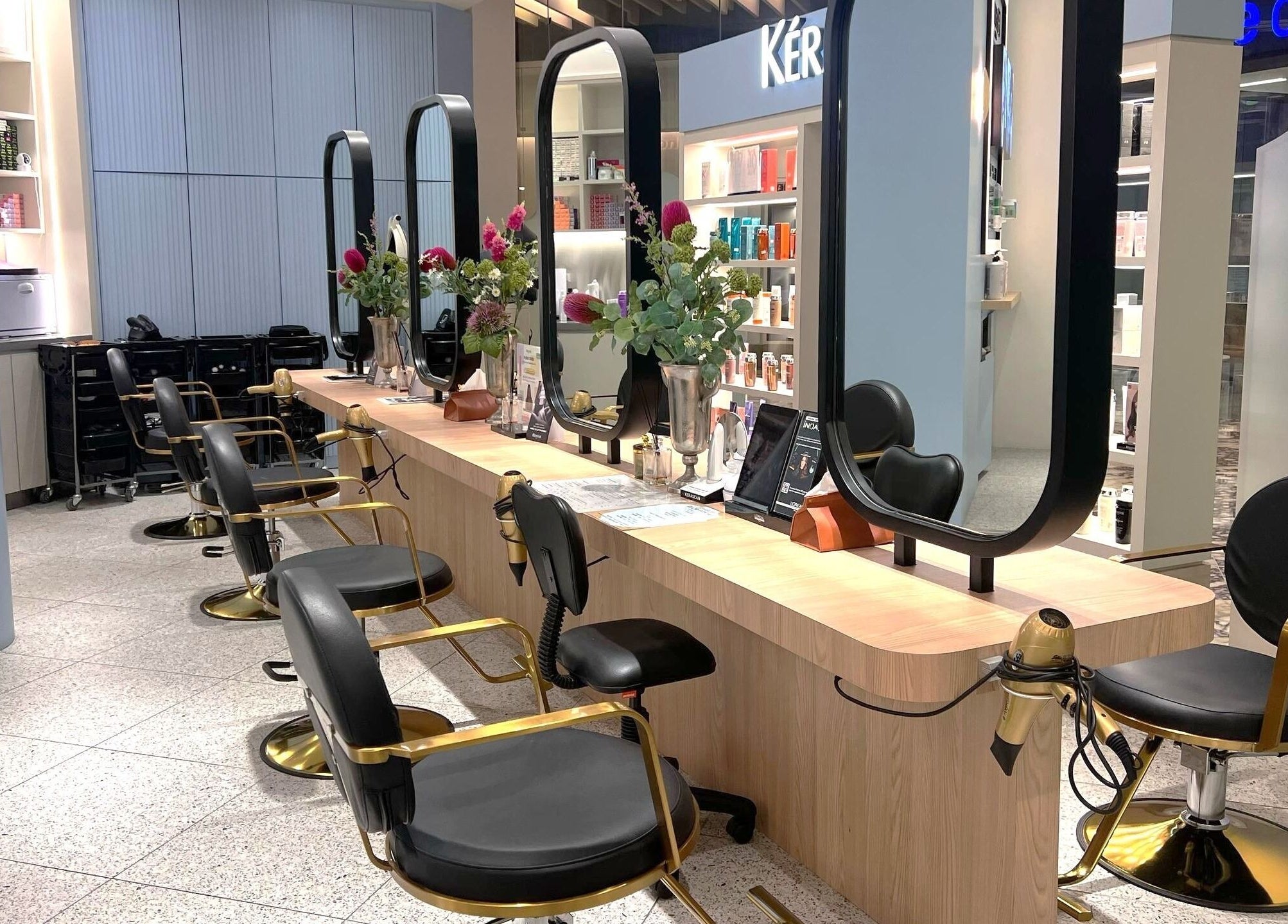 Elegant salon at Muse 106, Kuala Lumpur, features modern styling chairs and mirrors. A stylish beauty hub.