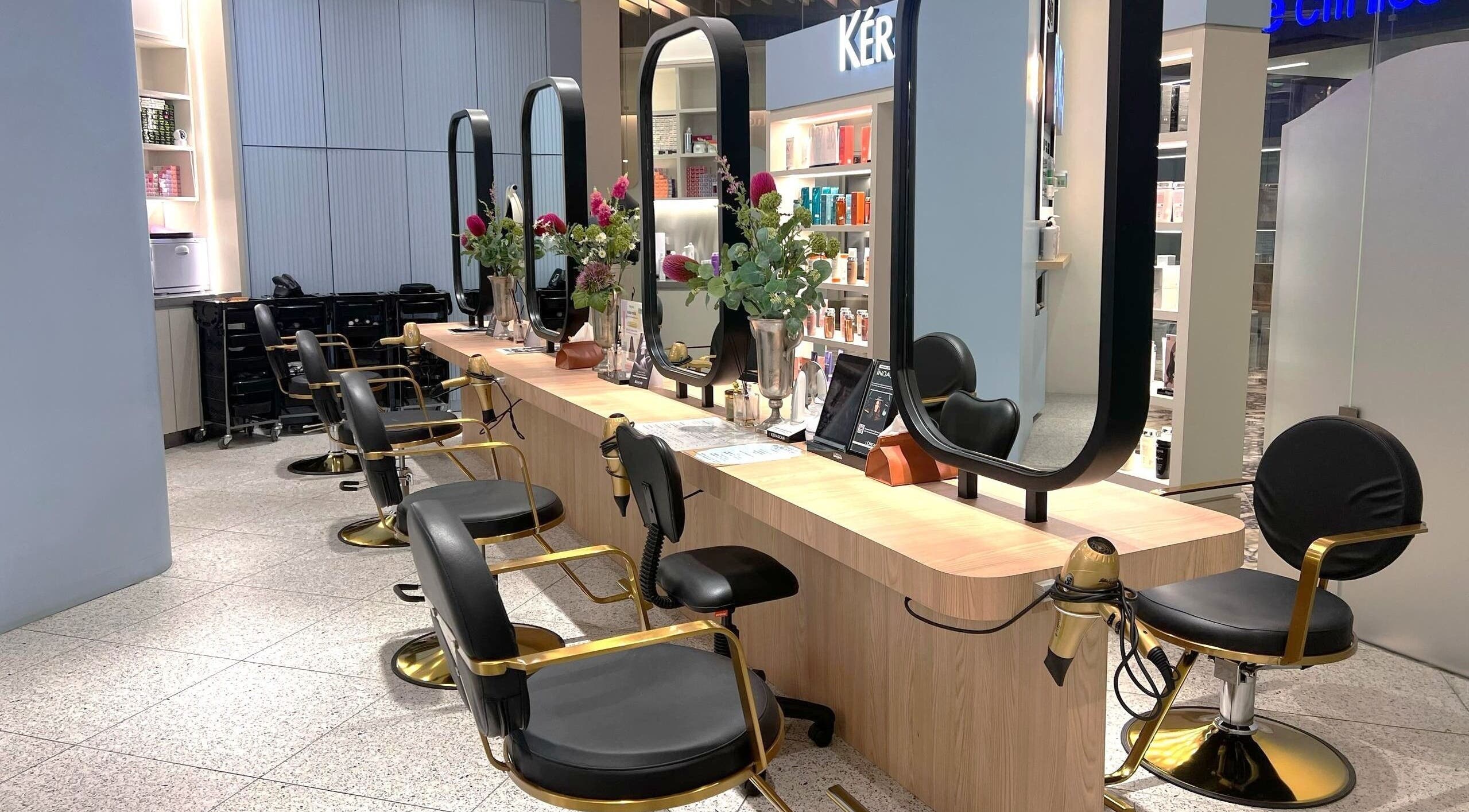Elegant salon at Muse 106, Kuala Lumpur, features modern styling chairs and mirrors. A stylish beauty hub.