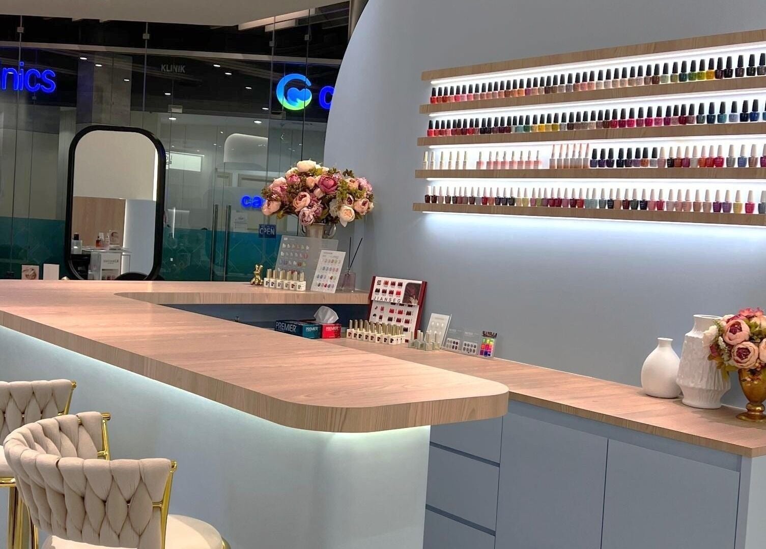 Interior of Muse 106 in Kuala Lumpur featuring a chic nail bar with elegant décor and vibrant polish collection.