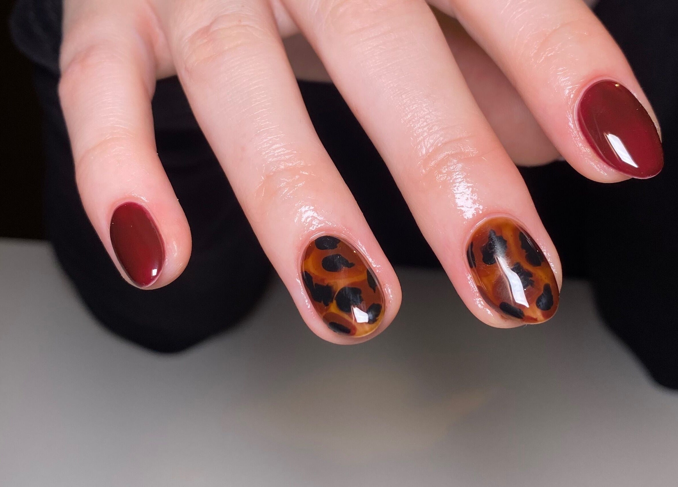 Elegant maroon nails with leopard print at The Nail Project by Deanna, Penicuik, Scotland, GB.