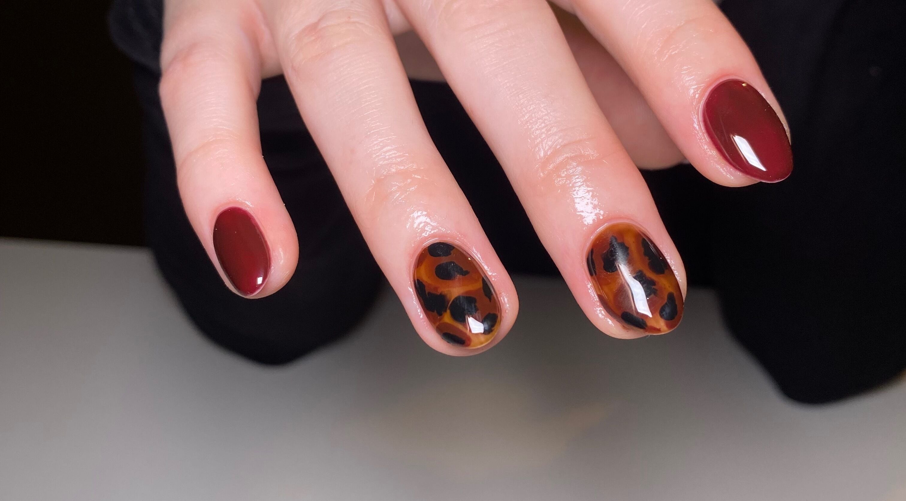 Elegant maroon nails with leopard print at The Nail Project by Deanna, Penicuik, Scotland, GB.