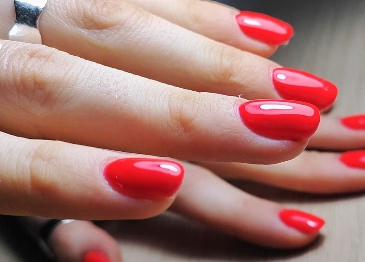 Vibrant red manicure at Feud Nails, Cardiff, Wales, GB. Perfectly polished nails showcasing expert nail artistry.