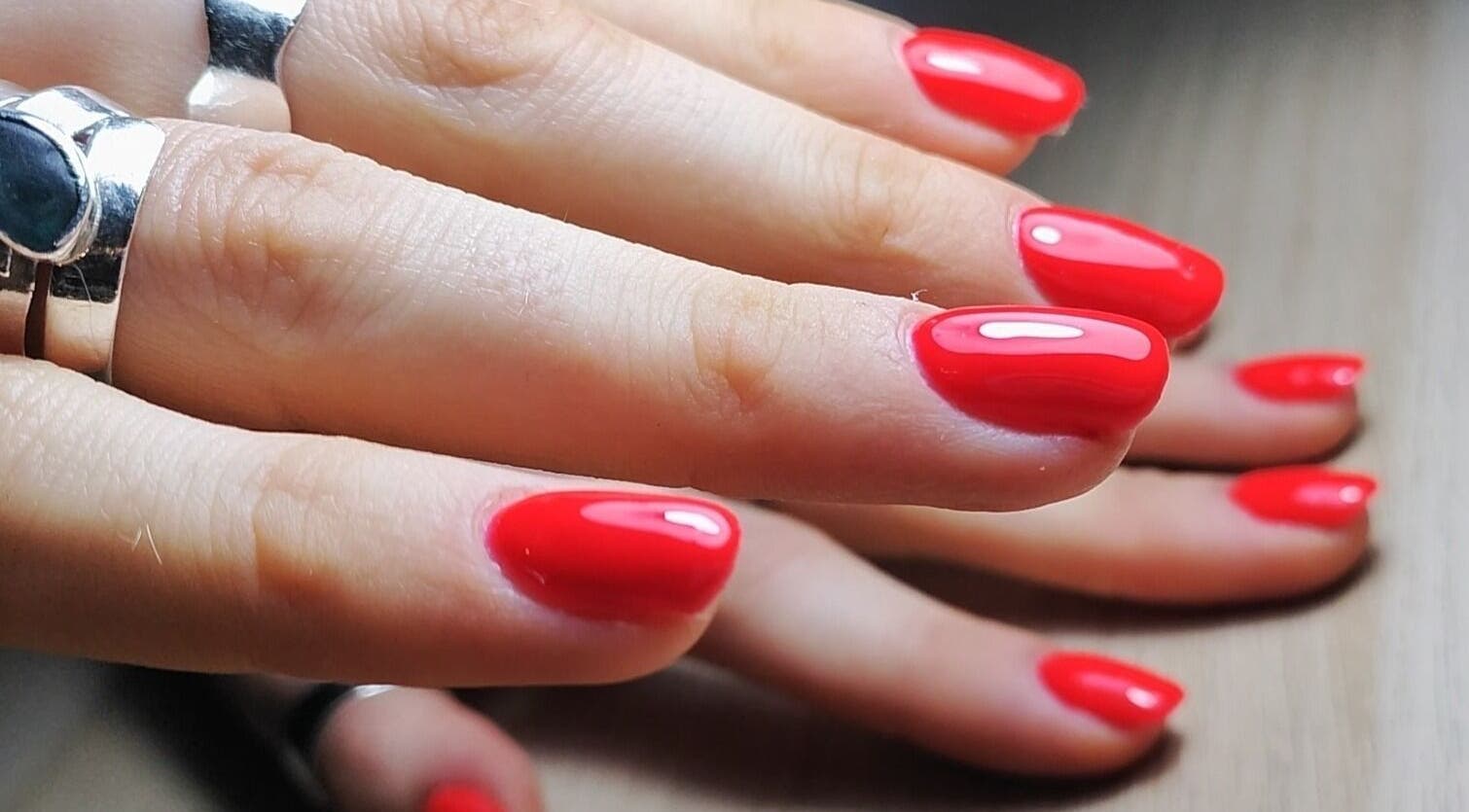 Vibrant red manicure at Feud Nails, Cardiff, Wales, GB. Perfectly polished nails showcasing expert nail artistry.