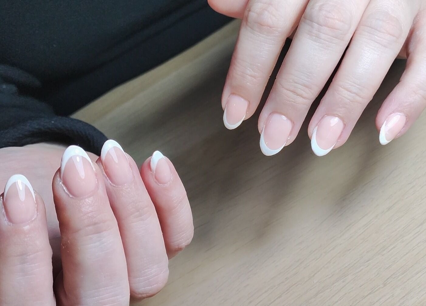 Beautiful French manicure at Feud Nails, Cardiff, Wales, GB showcasing neatly polished nails.