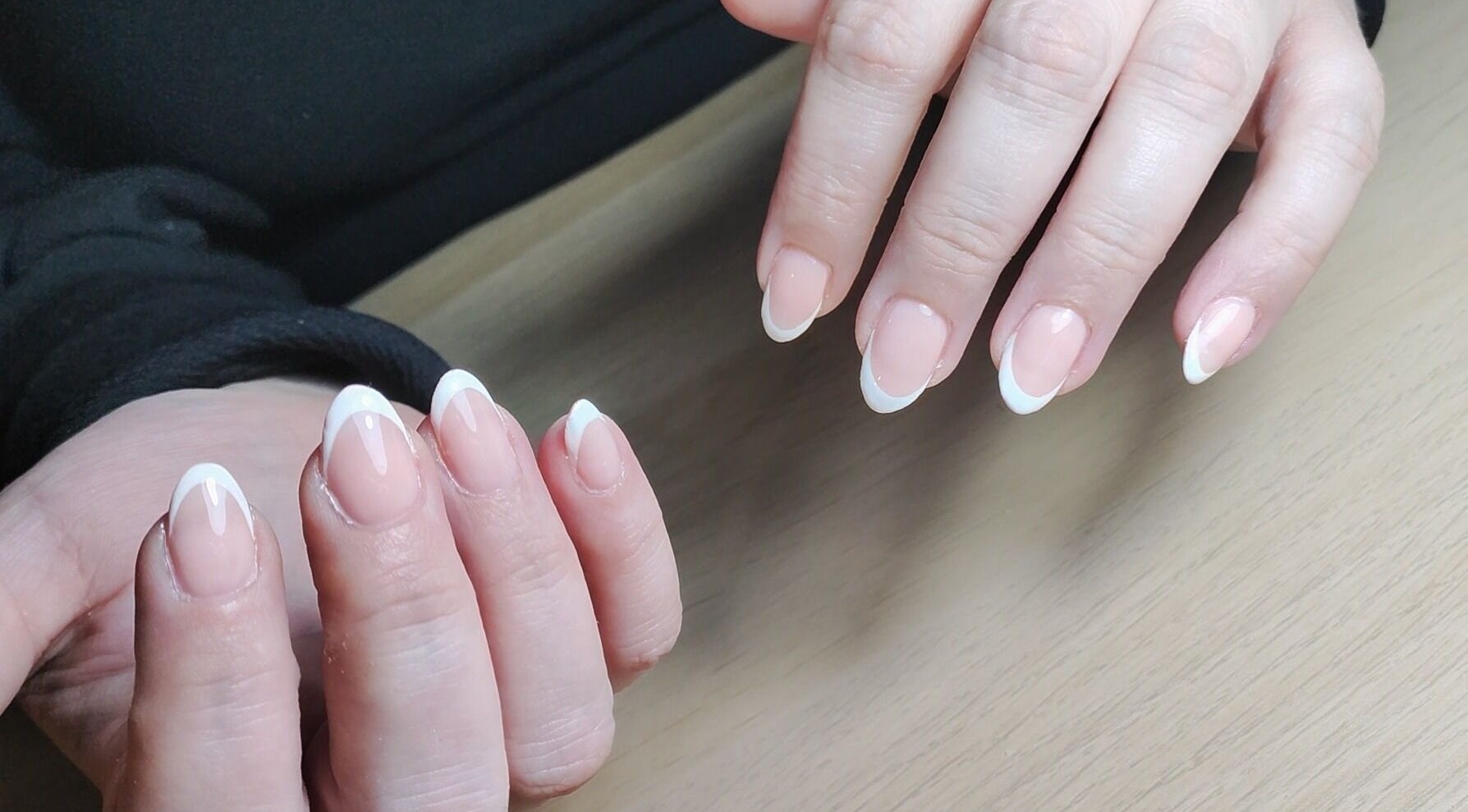 Beautiful French manicure at Feud Nails, Cardiff, Wales, GB showcasing neatly polished nails.