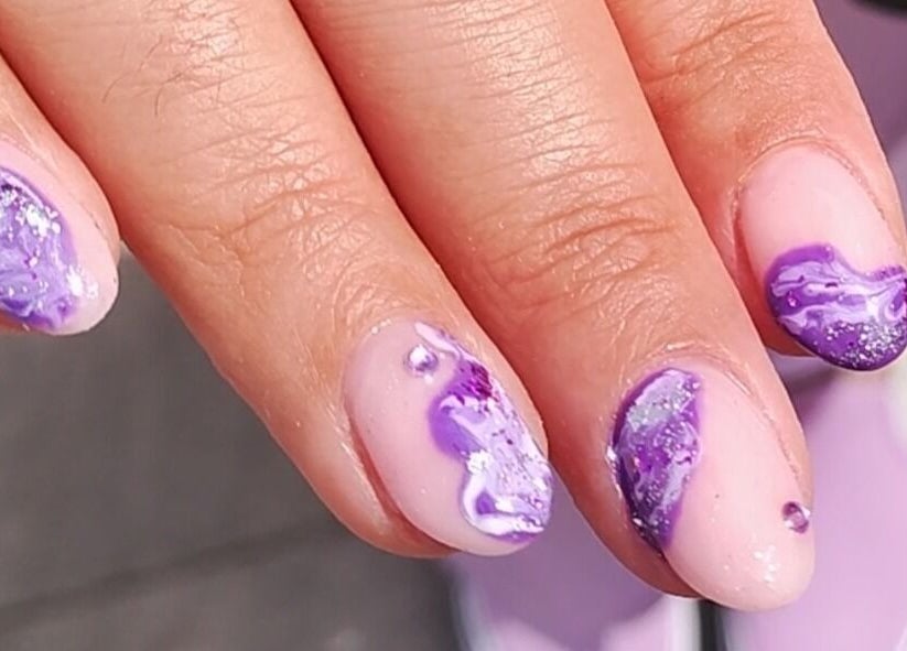 Elegant purple swirl nail art at Feud Nails, Cardiff, Wales, GB showcasing detailed artistry.