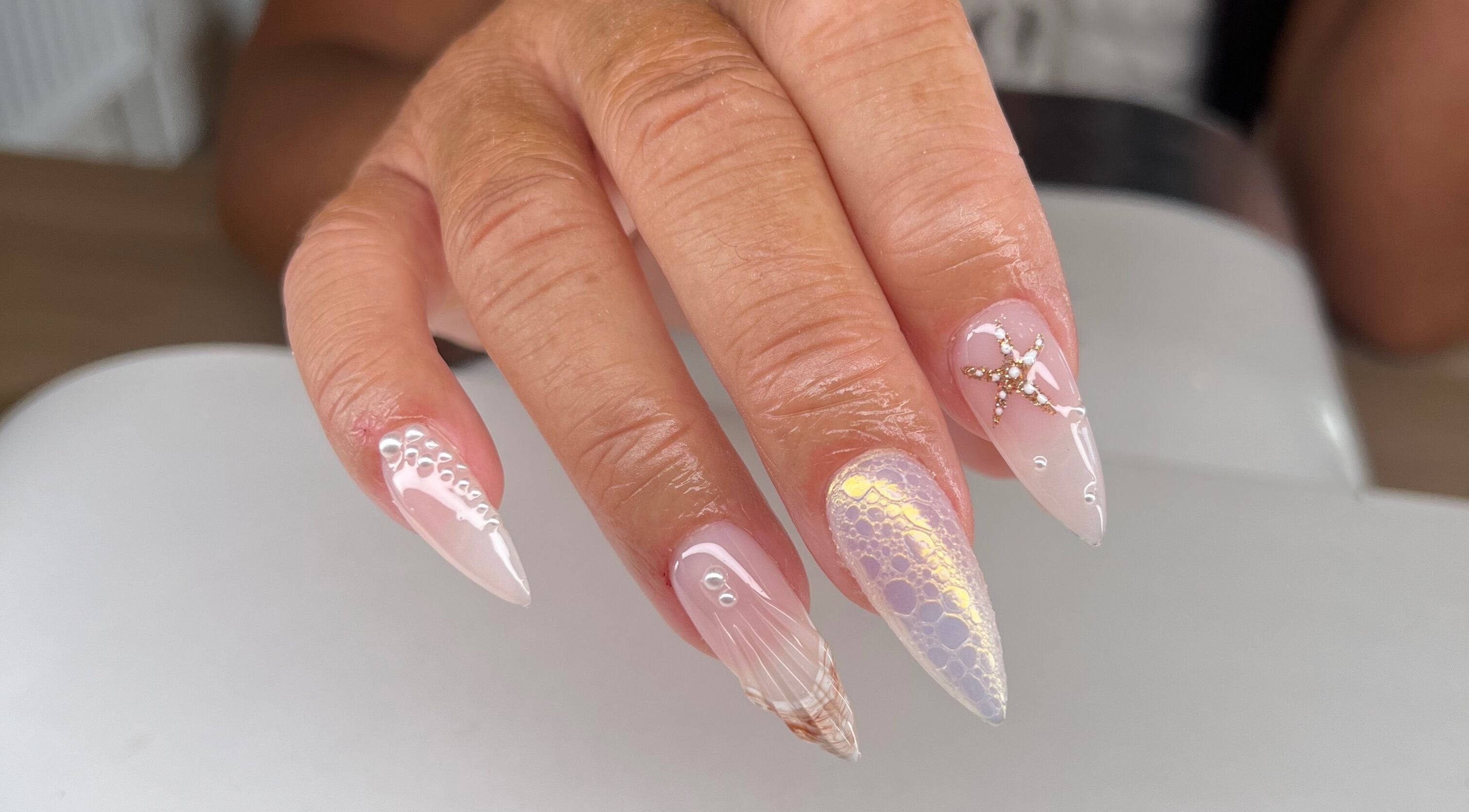 Elegant nail art in soft pinks with intricate designs by Abs Beauty, Barnsley, England, GB.
