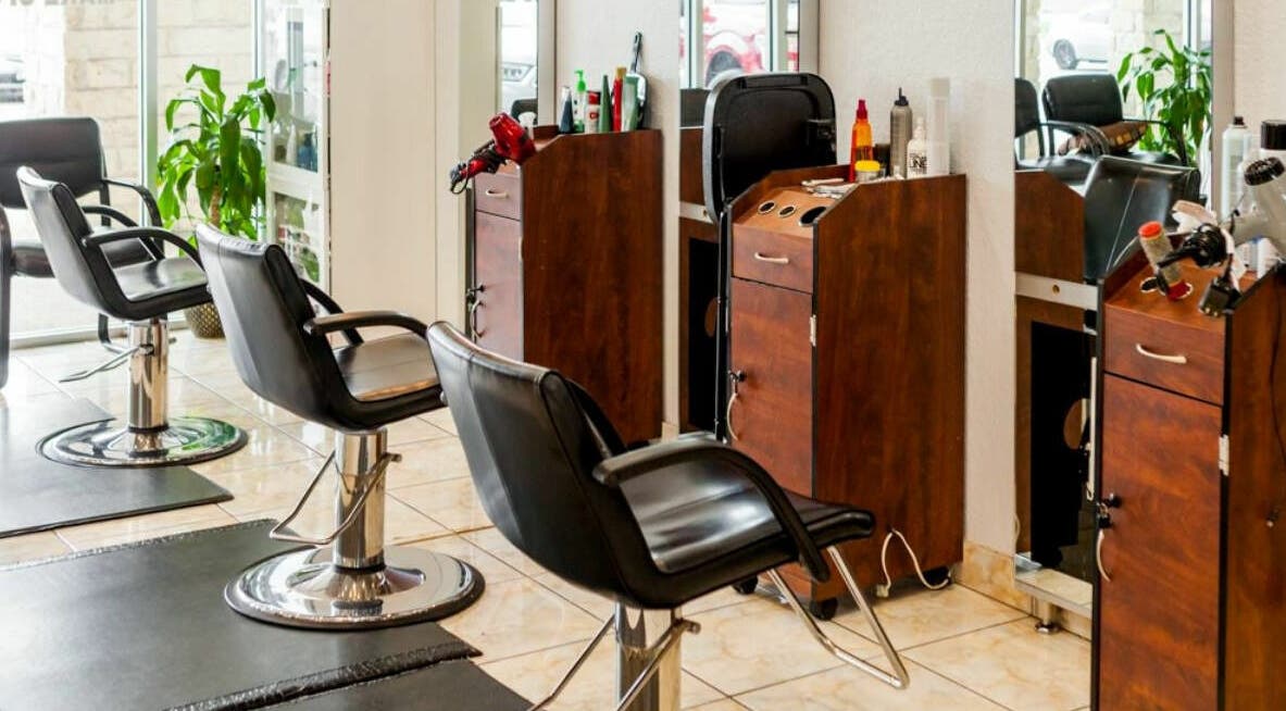 Modern interior of Elite Hair and Nail Salon in Justin, Texas, US showcasing stylish styling chairs and workstations.