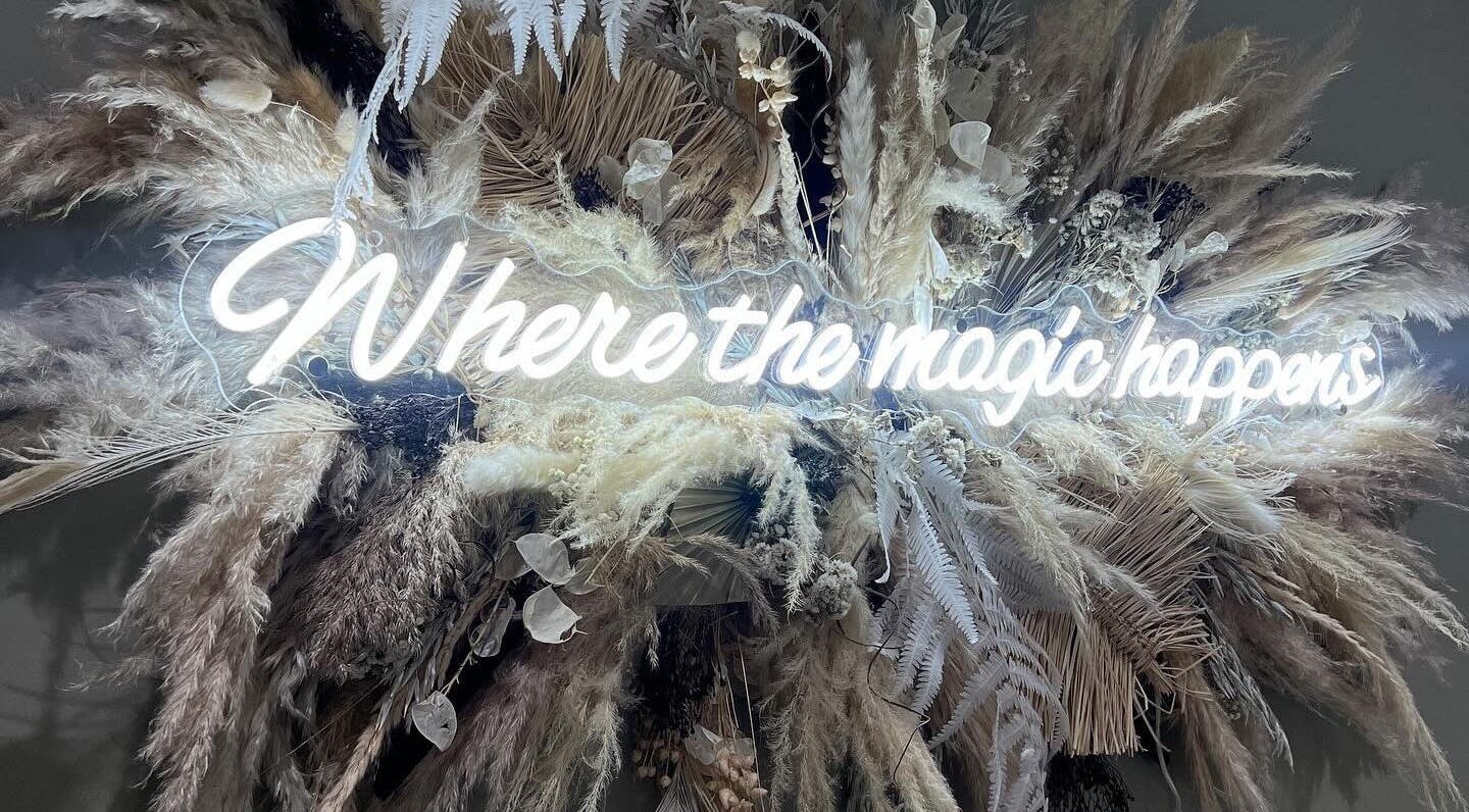 Illuminated 'Where the magic happens' sign at KN The Brow and Laser Lab, Ossett, England, GB.