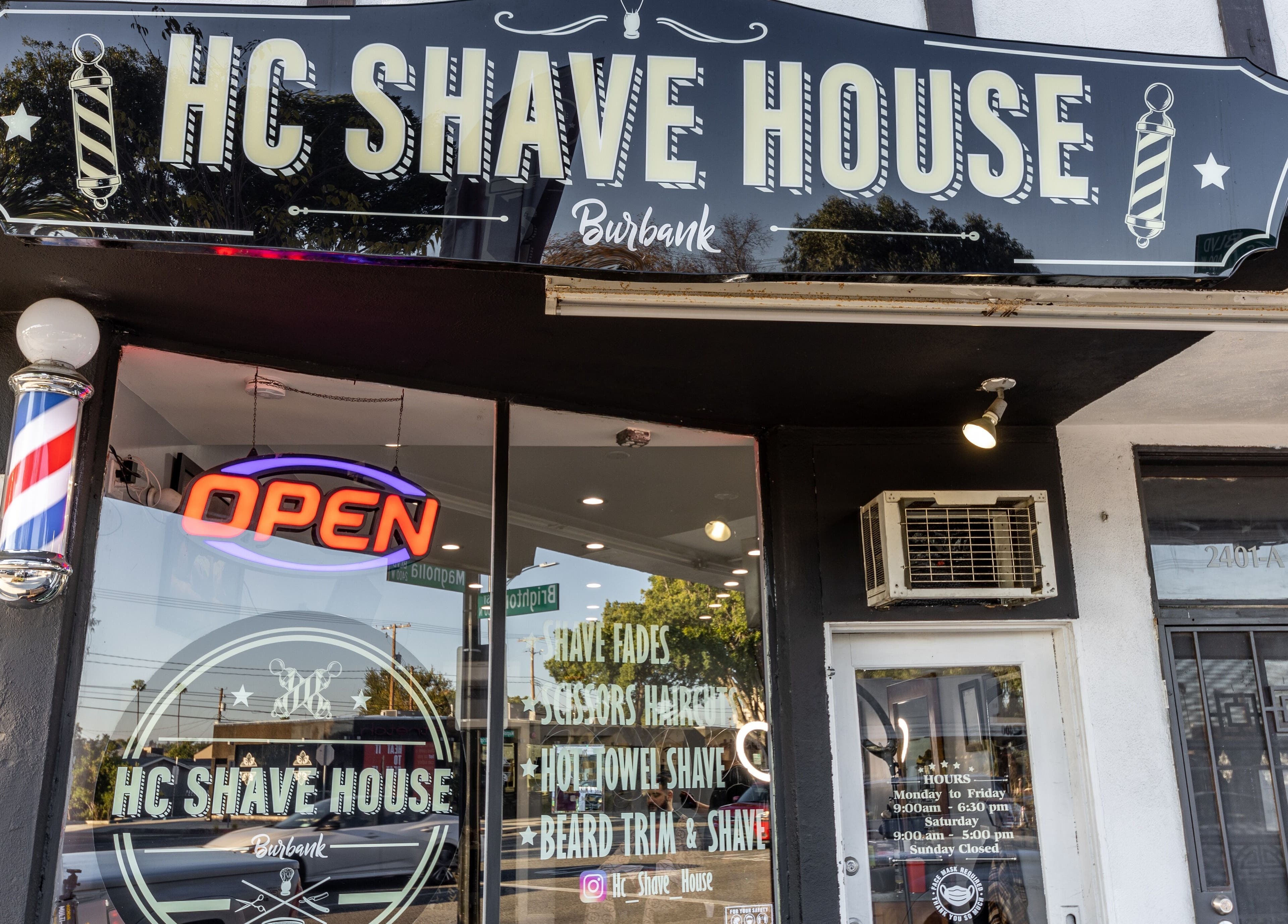Front view of HC Shave House, a classic barbershop in Burbank, California, US, with an open sign.