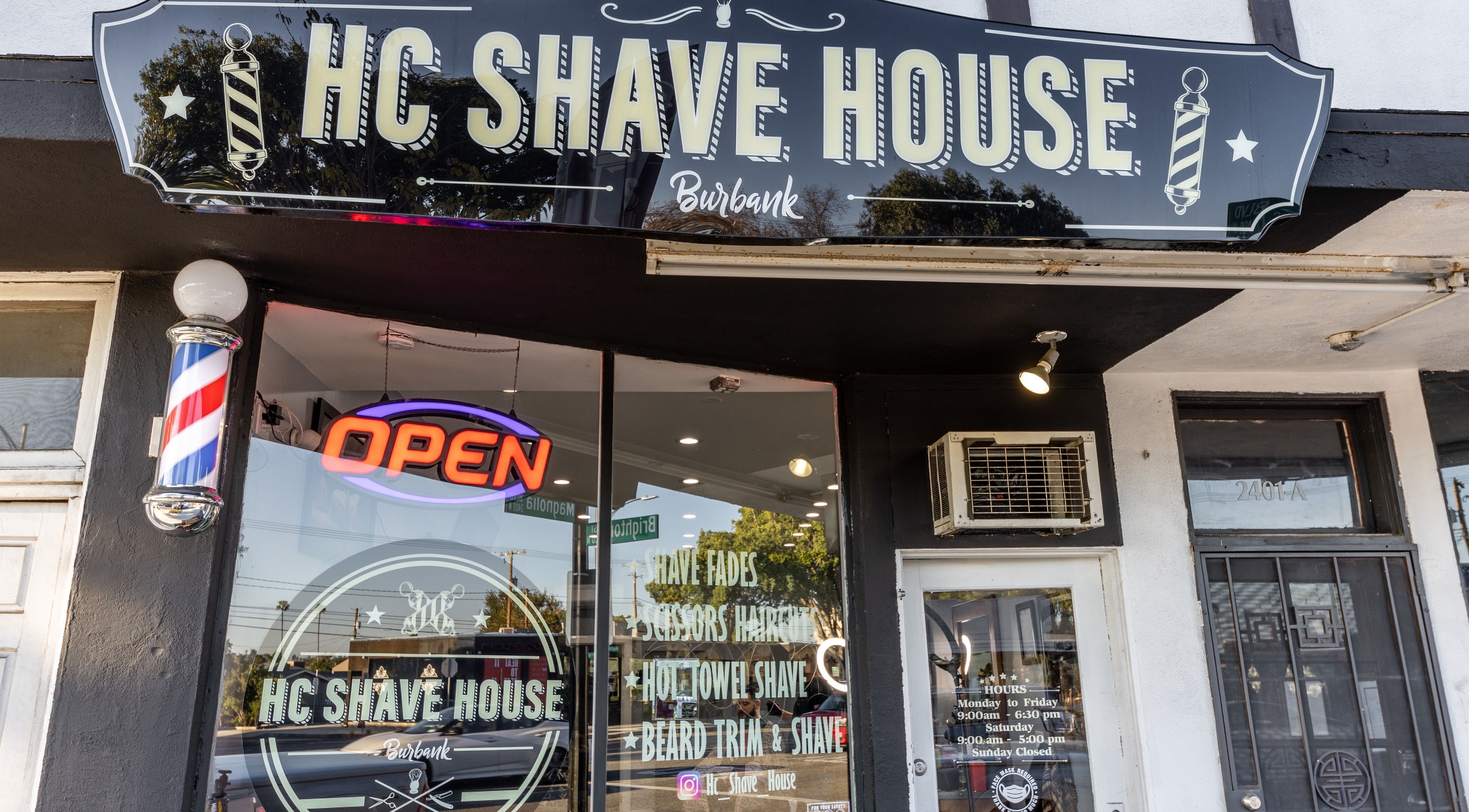 Front view of HC Shave House, a classic barbershop in Burbank, California, US, with an open sign.