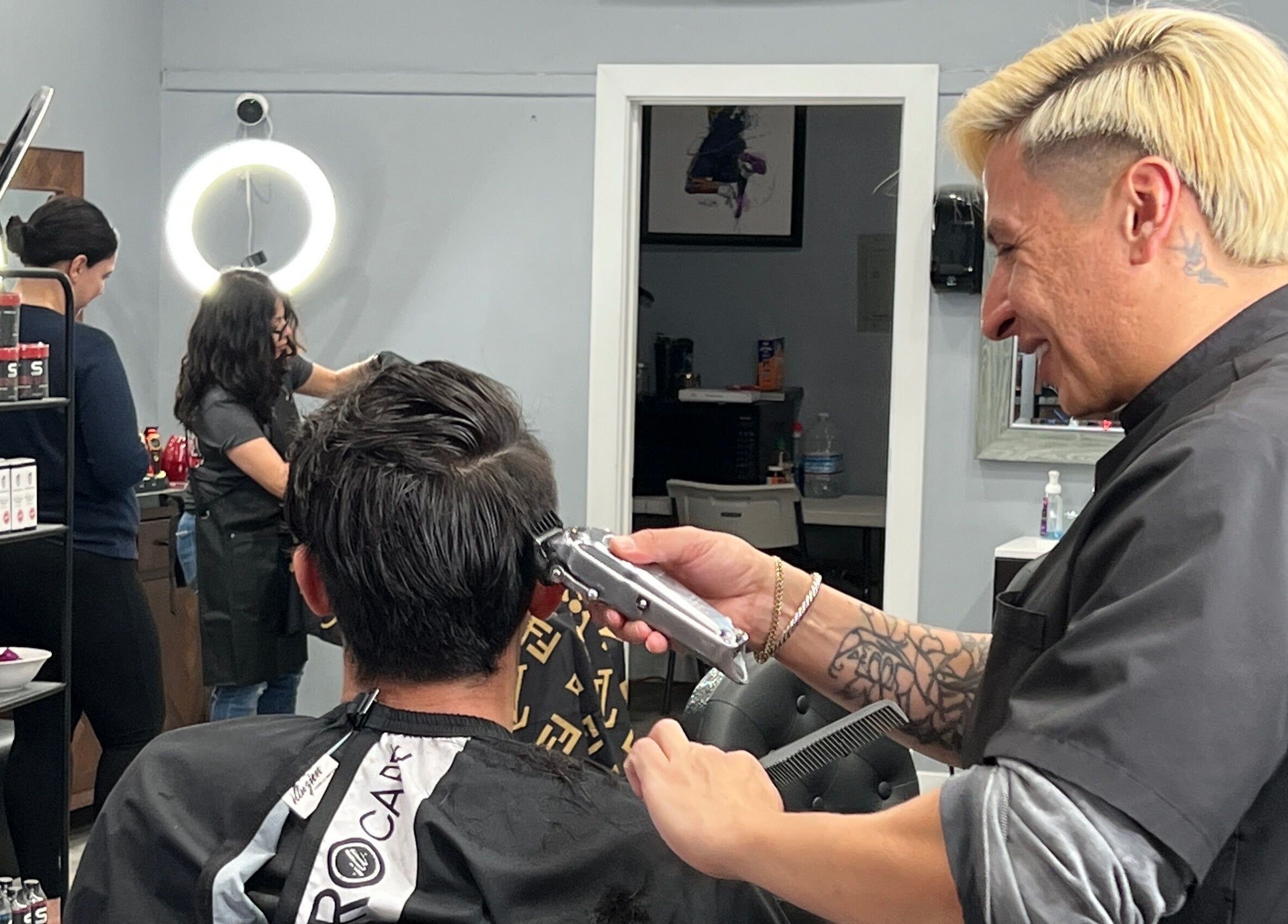 Stylist giving haircut at HC Shave House, Burbank, California, US.