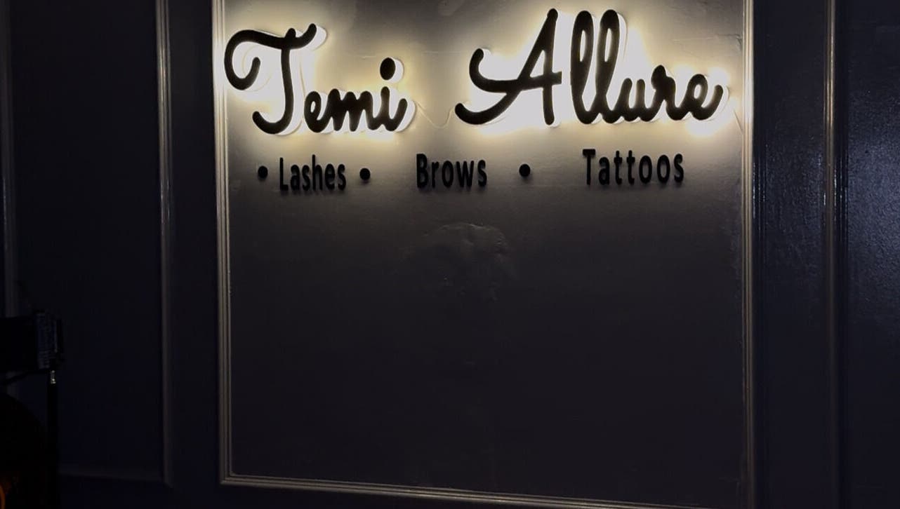 Illuminated sign at TemiAllureStudio in Lagos, Lagos, NG showcasing lashes, brows, tattoos.