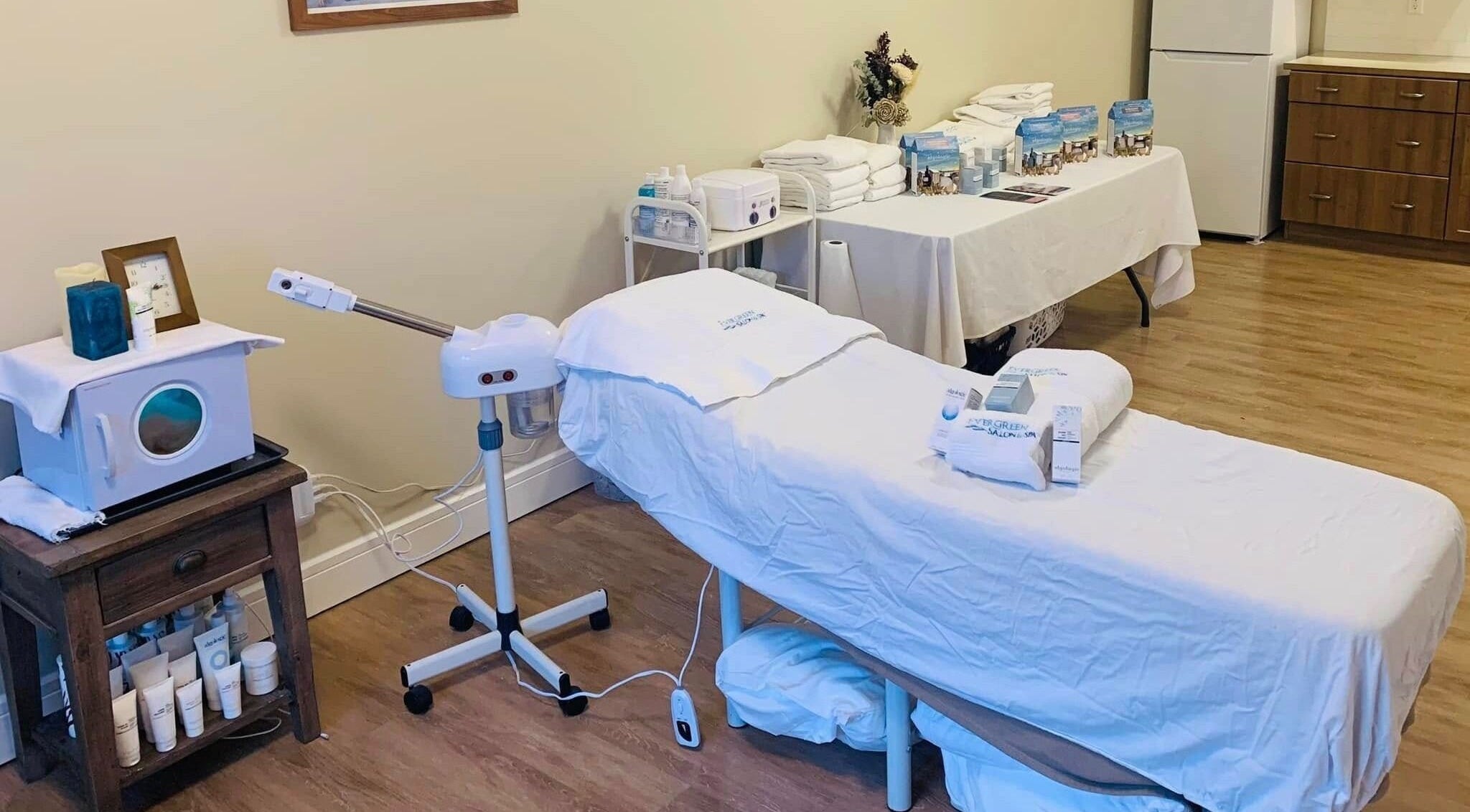 Relaxing spa treatment room at Hair and Beauty in the Woods, Canmore, Alberta, CA with a modern massage table.