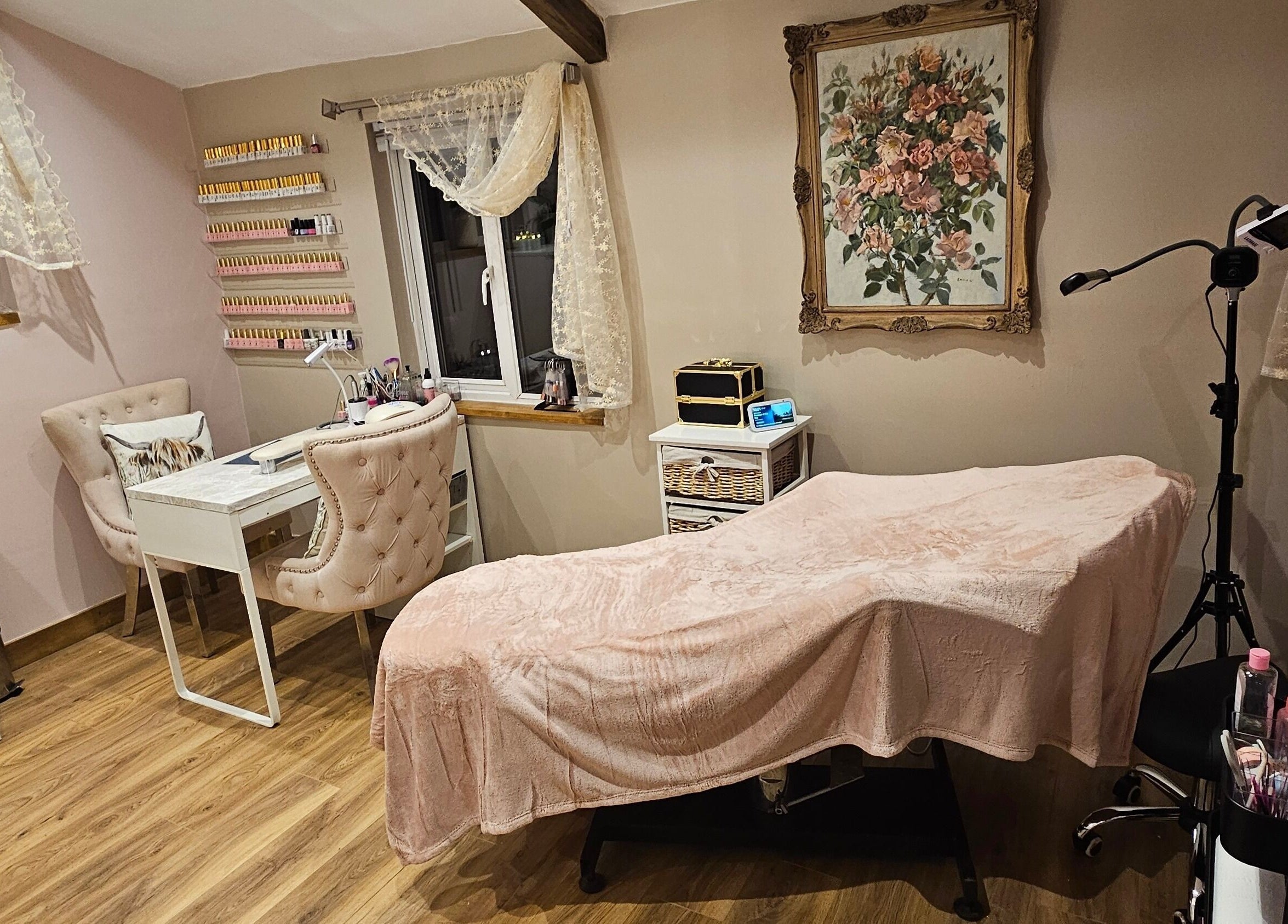 Stylish beauty room at On the Lash, Inwardleigh, United Kingdom, GB with treatment bed and manicure station.