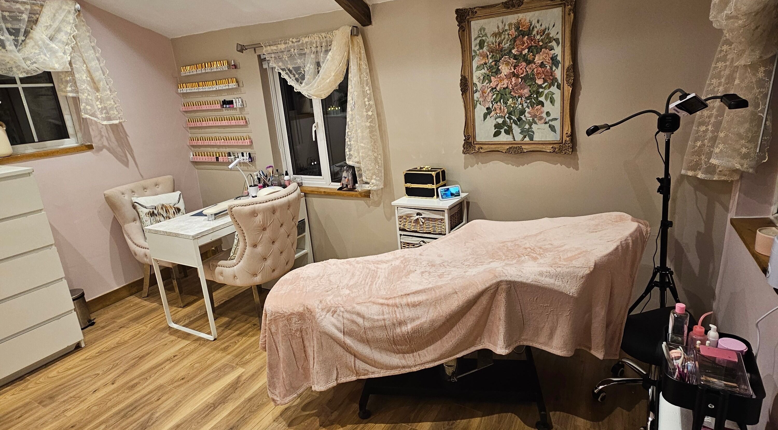 Stylish beauty room at On the Lash, Inwardleigh, United Kingdom, GB with treatment bed and manicure station.