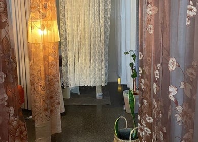 Calming decor at Siam Kinnaree Thai Massage in Fremantle, Western Australia, AU, featuring floral drapes and soft lighting.