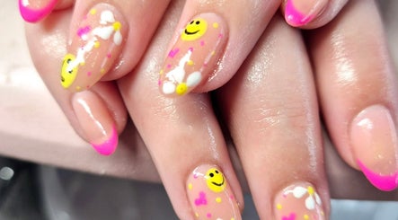 Colorful nail art with smiley faces at Sarah's Nails and Beauty in Cadishead, England, GB.