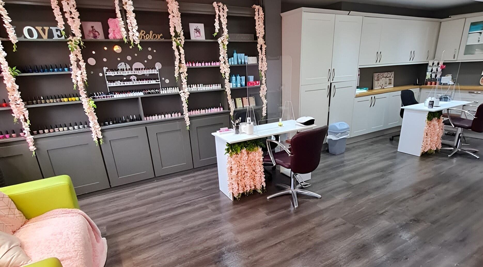 Elegant nail salon at Sarah's Nails and Beauty, Cadishead, England, with floral decor and stylish workstations.