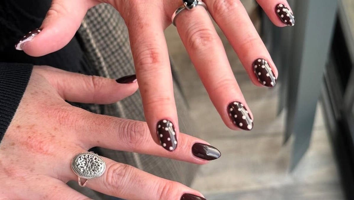 Chic polka dot nail art at Nailsbyzqt, Tāhuna, Ōtākou, NZ, showcasing detailed hand designs.