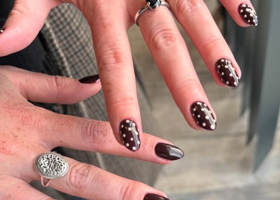 Chic polka dot nail art at Nailsbyzqt, Tāhuna, Ōtākou, NZ, showcasing detailed hand designs.