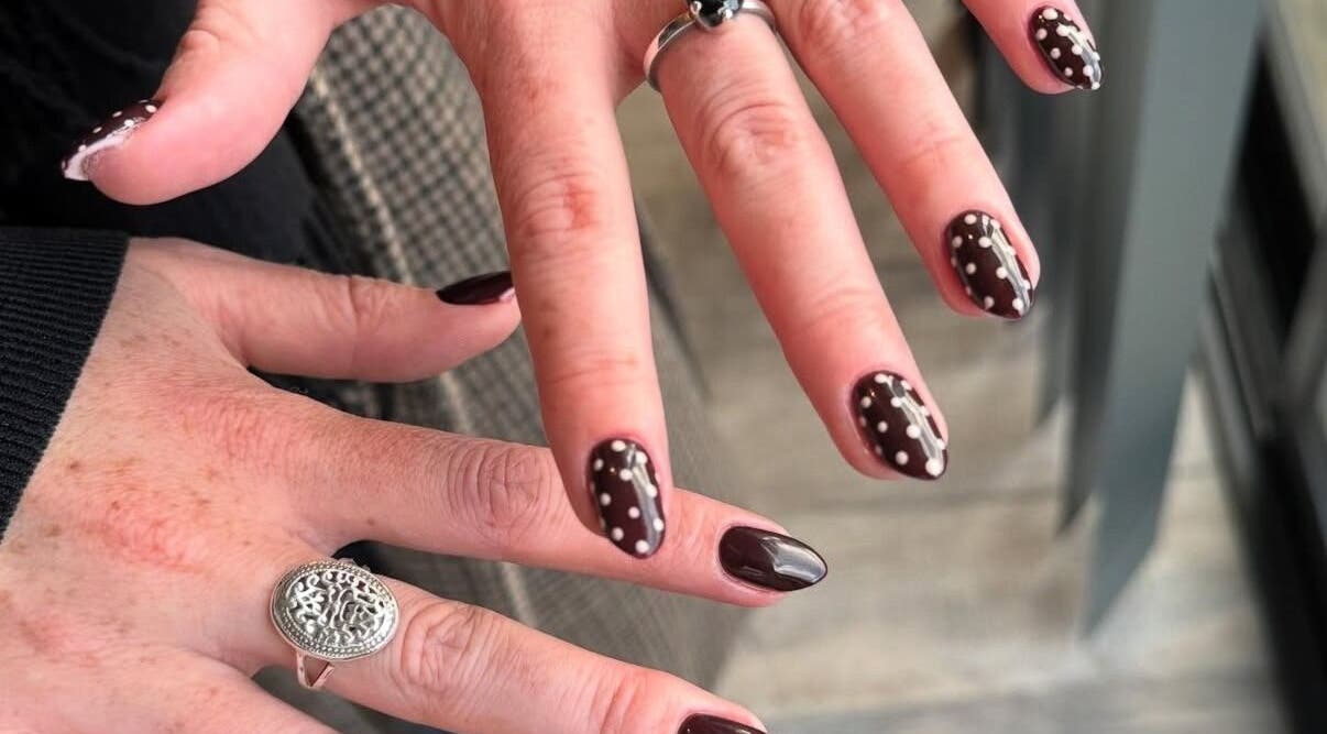Chic polka dot nail art at Nailsbyzqt, Tāhuna, Ōtākou, NZ, showcasing detailed hand designs.
