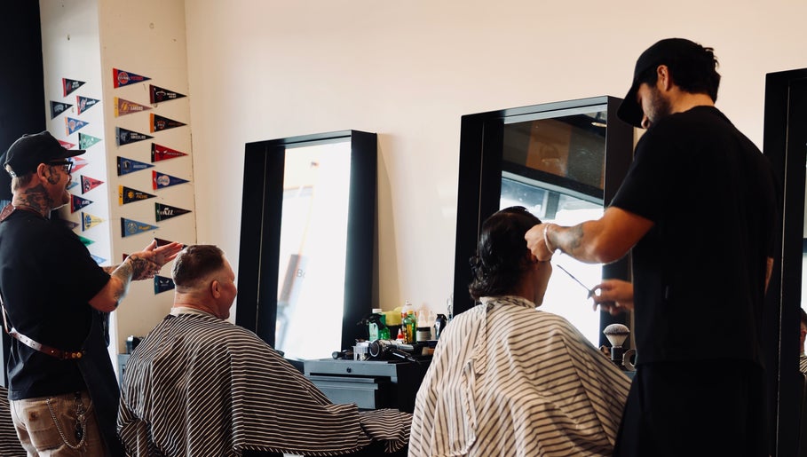 Barbers at Boar and Blade Ponsonby in Auckland, NZ, expertly styling clients' hair with precision.