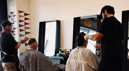 Barbers at Boar and Blade Ponsonby in Auckland, NZ, expertly styling clients' hair with precision.
