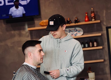 Barber crafting a modern haircut at Boar and Blade Ponsonby, Auckland, Auckland, NZ.