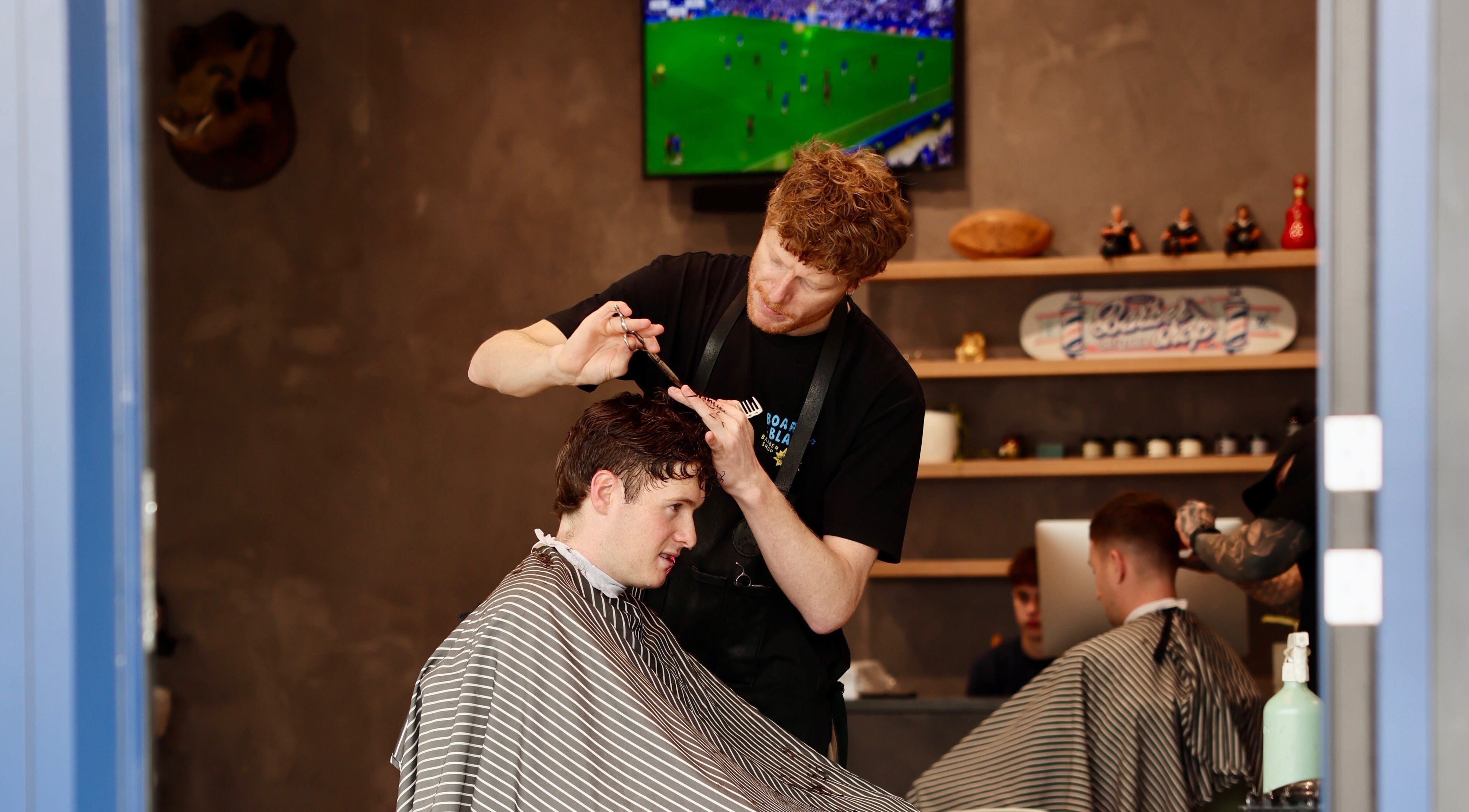 Barber styling hair at Boar and Blade Ponsonby, Auckland, Auckland, NZ.