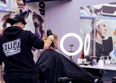 Barber styling hair at 1UP Barbershop Cockburn in Cockburn Central, Western Australia, AU.