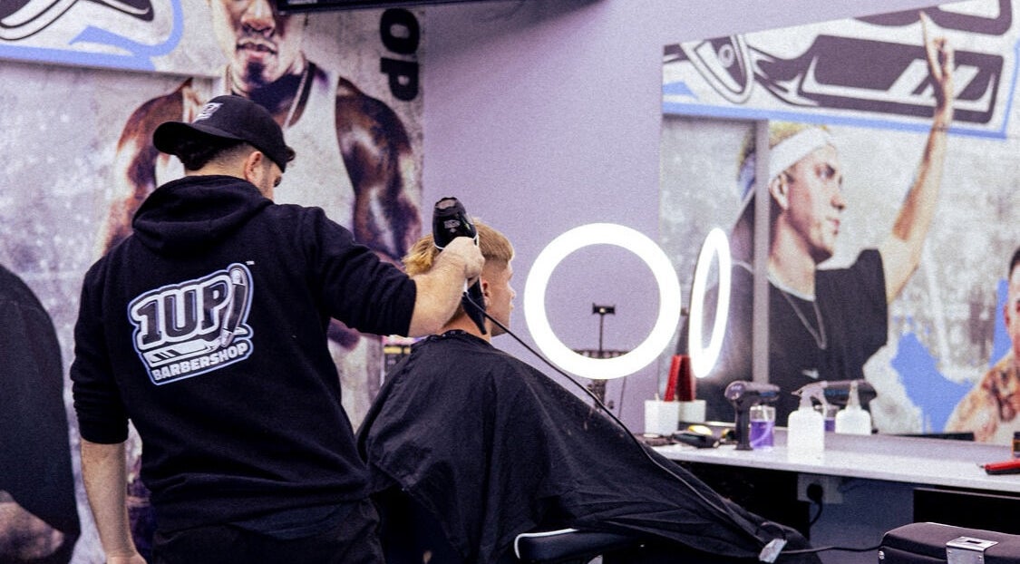 Barber styling hair at 1UP Barbershop Cockburn in Cockburn Central, Western Australia, AU.