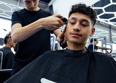 Stylist gives a haircut at 1UP Barbershop Cockburn, Cockburn Central, Western Australia, AU.