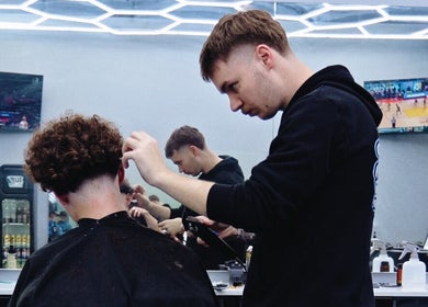 Barber expertly styling hair at 1UP Barbershop Cockburn, Cockburn Central, Western Australia, AU.