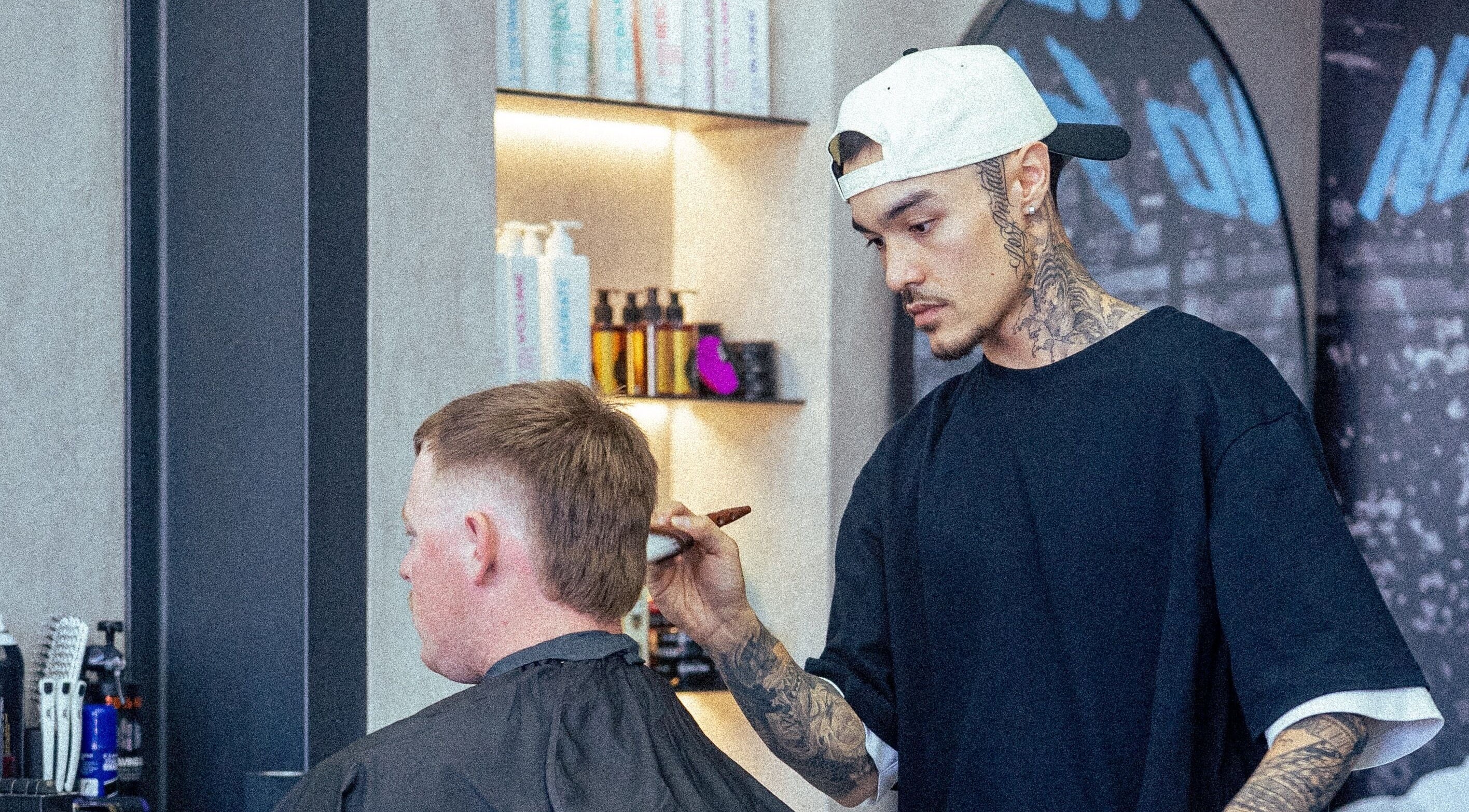 Barber at 1UP Barbershop Bicton styling a client's hair, in Bicton, Western Australia, AU.