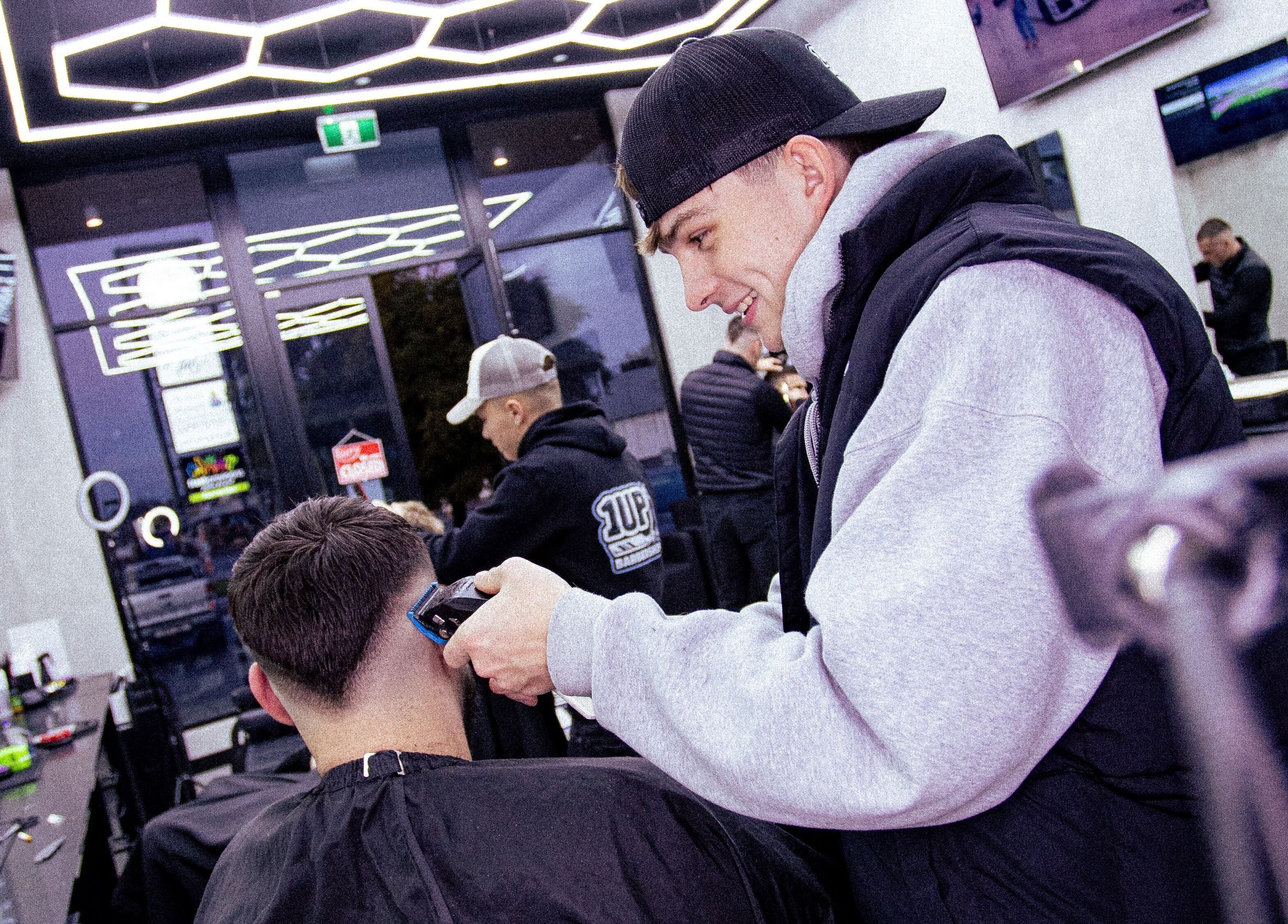 Expert barber at 1UP Barbershop Bicton performing a stylish haircut in Bicton, Western Australia, AU.