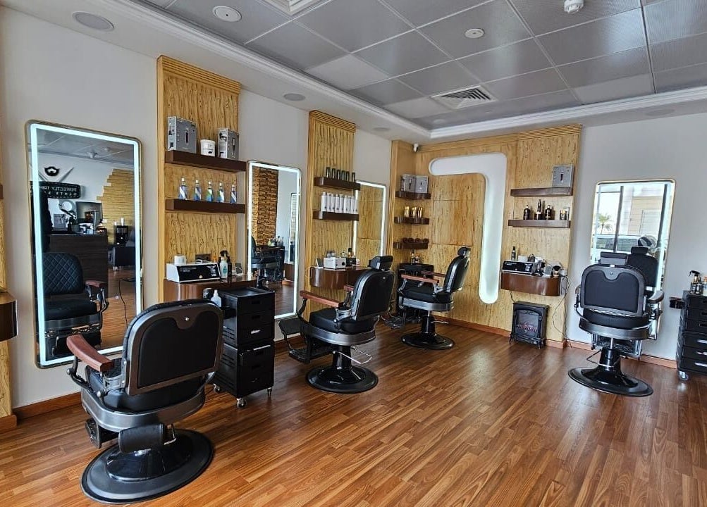 Interior of Perfectly Trimmed Gents Salon, Abu Dhabi, AE featuring sleek barber chairs and modern decor.