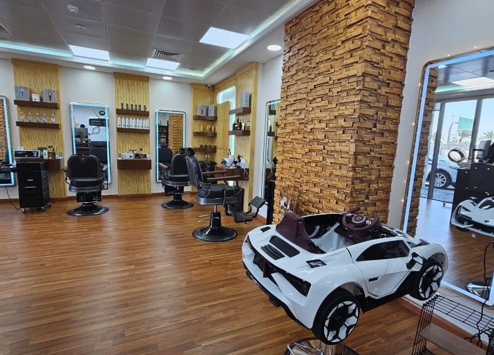Modern interior of Perfectly Trimmed Gents Salon, Abu Dhabi, AE with elegant barber chairs and rustic decor.
