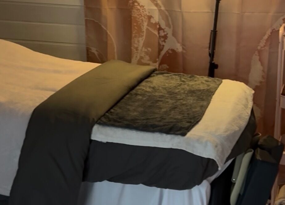 Relaxing treatment room at The Happy Skin Technician, Sheffield, England, GB. Cozy bed and skincare products in view.