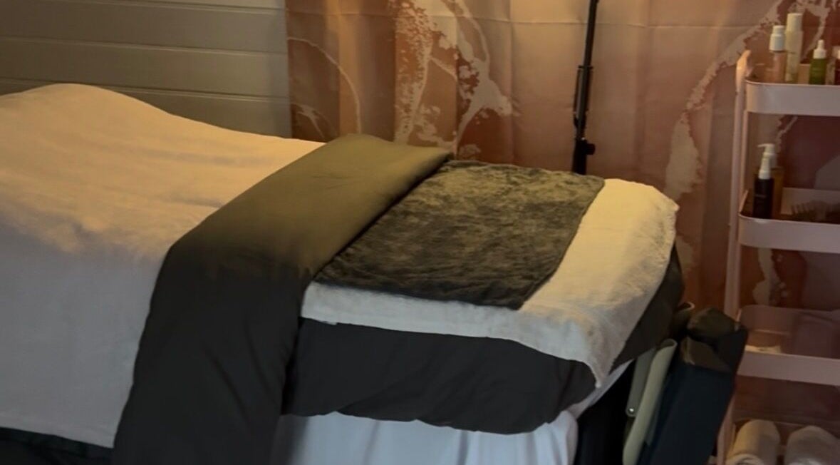 Relaxing treatment room at The Happy Skin Technician, Sheffield, England, GB. Cozy bed and skincare products in view.