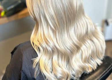 Blonde hair with soft waves styled at Gina Marks Hair in Elmswell, England, GB.