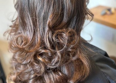 Stylish curly hair at Gina Marks Hair in Elmswell, England, GB showcasing professional hairstyling.