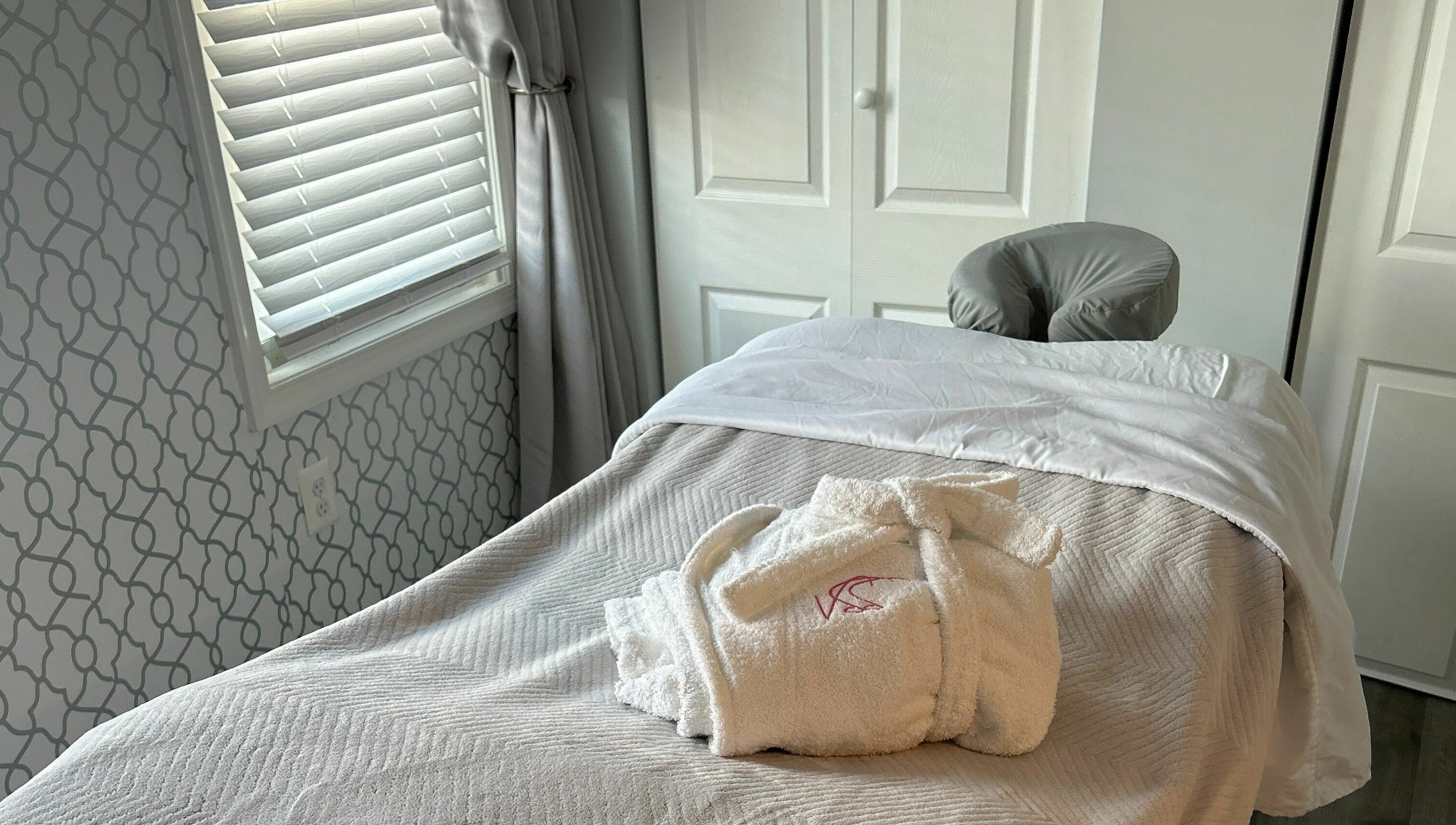 Cozy treatment room at Village Skin Sanctuary in Audubon, Pennsylvania, showcasing a massage table with plush linens.