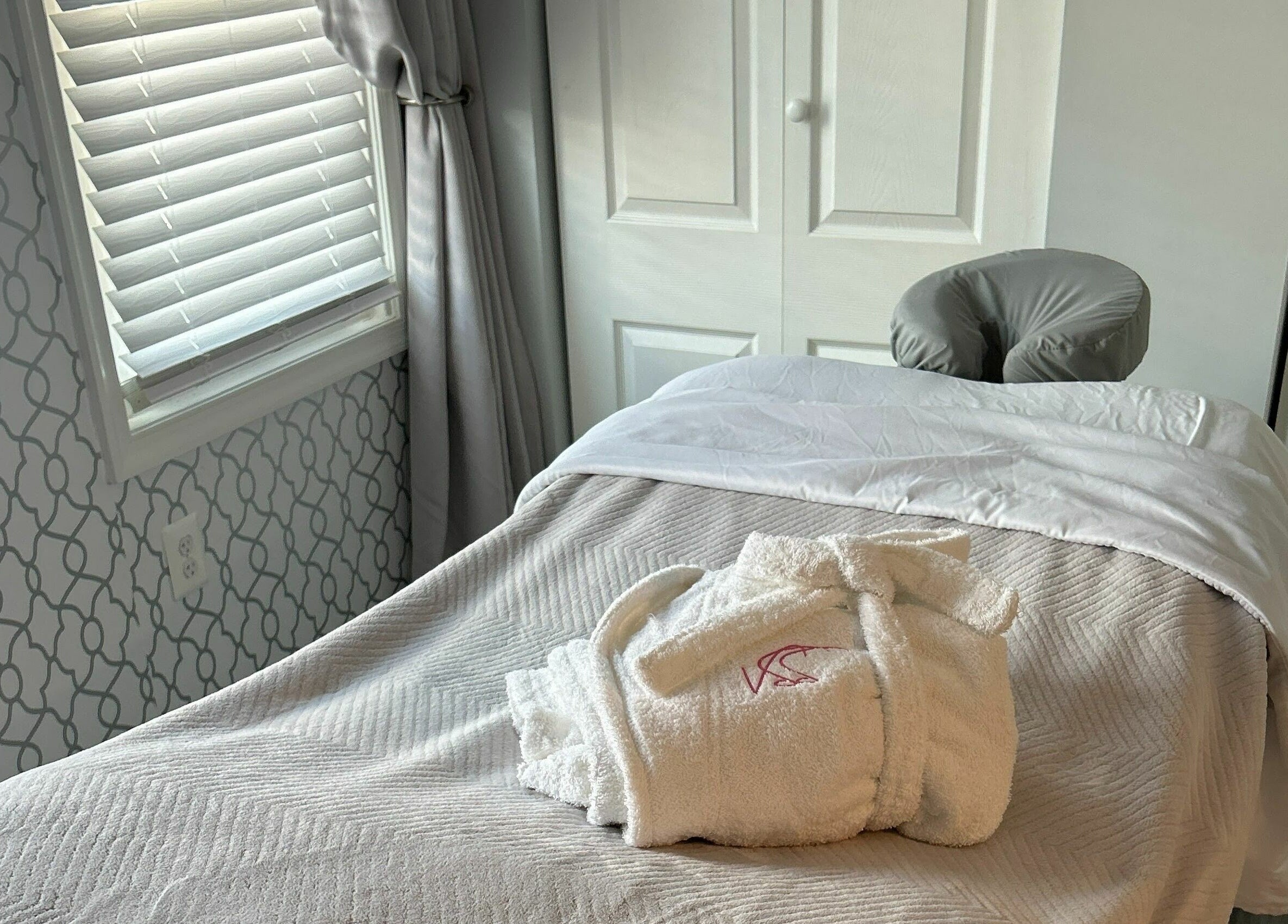 Cozy treatment room at Village Skin Sanctuary in Audubon, Pennsylvania, showcasing a massage table with plush linens.
