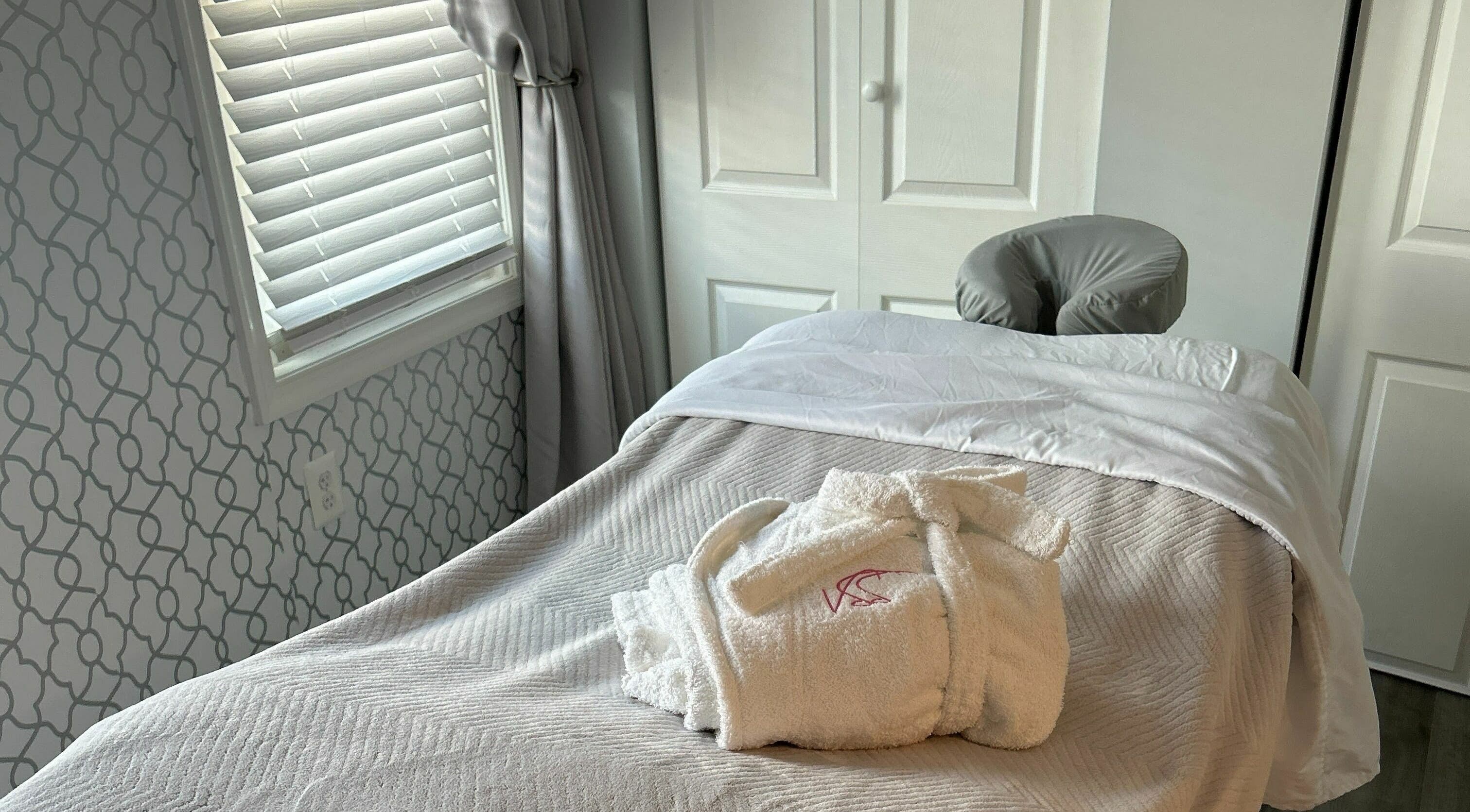 Cozy treatment room at Village Skin Sanctuary in Audubon, Pennsylvania, showcasing a massage table with plush linens.